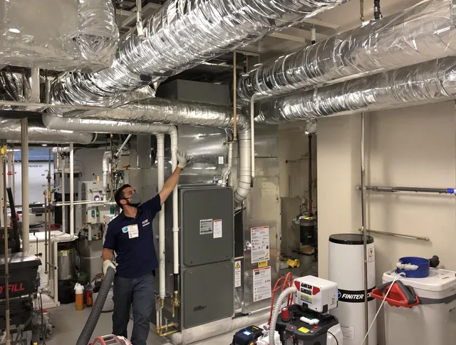Wayland Air Duct Cleaning specialist performing thorough furnace duct cleaning in a Wayland residence