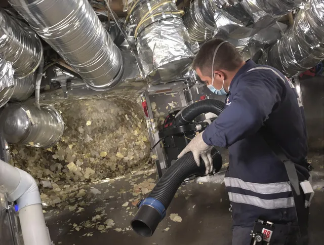 Wayland Air Duct Cleaning specialist operating negative pressure cleaning equipment for thorough duct maintenance in Wayland