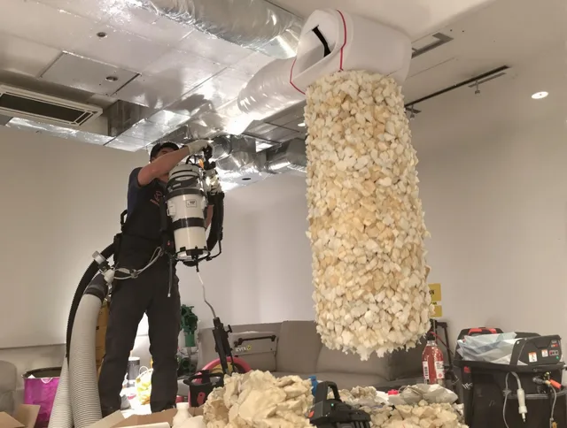 Wayland Air Duct Cleaning technician performing precision vacuum insulation removal in a residential property in Wayland