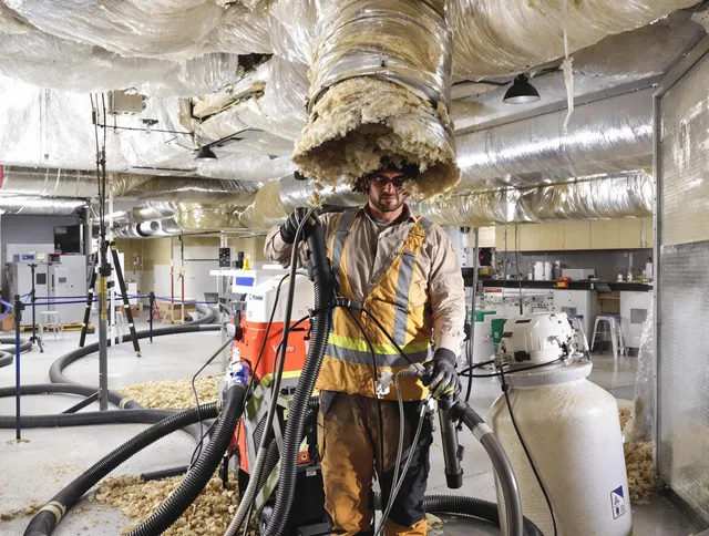 Professional vacuum insulation removal by Wayland Air Duct Cleaning expert in Wayland